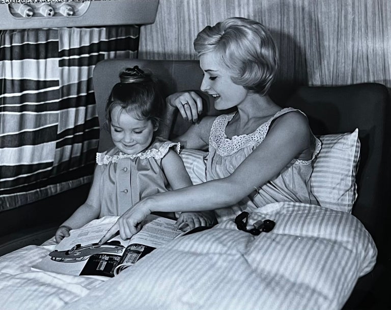 Item #227261 1960s Glossy Black and White Photo of a Mother and Child on a Lufthansa Flight. Lufthansa Airlines.