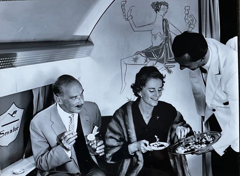 Item #227269 1960s Glossy Black and White Photo of Two Lufthansa First Class Passengers Enjoying Hors d'oeuvres in Flight. Lufthansa Airlines.